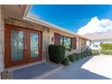 Close up of the double door entry with stone accents and a concrete drive at 35 Sabal Dr, Punta Gorda, FL 33950