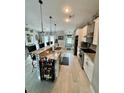 Modern kitchen featuring an extended island with barstool seating and sleek, stainless steel appliances at 3714 Gulfbreeze Ln, Punta Gorda, FL 33950