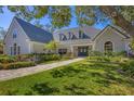 Beautiful home with a gray tile roof, lush landscaping, and a paved walkway leading to the front door at 4 Saint Martin Cir, Englewood, FL 34223