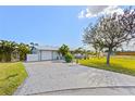 Charming single story home featuring a two-car garage and a well-maintained lawn with mature landscaping at 5196 Early Ter, Port Charlotte, FL 33981