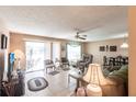 Relaxing living room featuring tile flooring, comfortable seating and natural light from sliding glass doors to patio at 8029 Roy Dr, Punta Gorda, FL 33982