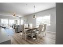 Dining area featuring a large table and modern lighting at 8403 Placida Rd # 408, Placida, FL 33946