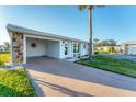 Well-kept single-story home with a carport, desert landscaping, and inviting curb appeal at 92 Circlewood Dr # B3-1, Venice, FL 34293