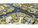 Wide angle aerial view of neighborhood showcasing single Gathering homes on waterfront lots and canals at 9428 Bandera Ln, Port Charlotte, FL 33981