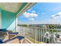 Enjoy stunning waterfront views from this spacious balcony with comfortable seating at 11723 1St E St, Treasure Island, FL 33706