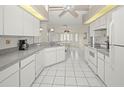 Bright kitchen featuring white cabinetry, tile backsplash, and views of the breakfast nook at 1364 Ultramarine Ln, Punta Gorda, FL 33983