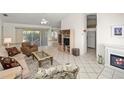 Inviting living room featuring tile floors, a fireplace, sliding glass doors, and comfortable seating at 1364 Ultramarine Ln, Punta Gorda, FL 33983