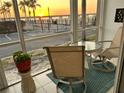 Cozy screened porch with comfortable seating and a lovely view of the sunrise over the water at 150 Harborside Ave # 122, Punta Gorda, FL 33950