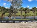 Serene pond reflecting the sky, bordered by lush trees, emphasizing the landscape's natural beauty at 1790 New London St, North Port, FL 34288