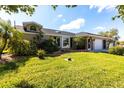 Charming single-story home with attached garage, bay window and manicured lawn and landscaping at 19179 Aviation Ct, Port Charlotte, FL 33948