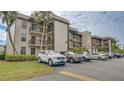 Exterior of building featuring balconies and parking at 1999 Kings Hwy # 21A, Punta Gorda, FL 33980