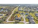 Aerial shot of a lovely home in a quiet neighborhood with water views and lush landscaping at 295 Porto Alegre St, Punta Gorda, FL 33983