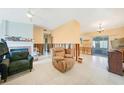 Open-concept living room with fireplace, tile flooring, and natural light at 3120 Wisteria Pl, Punta Gorda, FL 33950