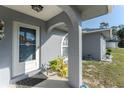 Front entrance with decorated glass door, archway, and updated landscaping at 349 Grenada St, Port Charlotte, FL 33948