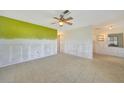 Spacious living room with tile floors, ceiling fan and natural light with view to another room through a large entrance at 3615 Sleepy Hollow Ln, Punta Gorda, FL 33950