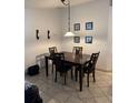 Formal dining area includes a dark wood table set for four, beneath a pendant light fixture at 376 Vitorio St, Punta Gorda, FL 33983