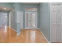 Bright foyer with light hardwood floors, a double door entry, and neutral paint at 10256 Shadow Run Ct, Punta Gorda, FL 33955
