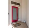 Inviting front door featuring a colorful glass pane design and a welcoming 