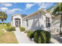 Charming home featuring a barrel tile roof, decorative rocks, and well-maintained landscaping at 10256 Shadow Run Ct, Punta Gorda, FL 33955