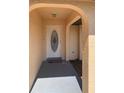 A close up front door with an arched covered entry and light yellow stucco at 20408 Andover Ave, Port Charlotte, FL 33954
