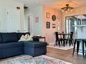 Living room with a cozy breakfast nook, adorned with wall decor and a modern chandelier at 21938 Catherine Ave, Port Charlotte, FL 33952
