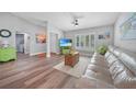 Inviting living space featuring wood floors, neutral decor, and a comfortable seating area at 23254 Stelling Ave, Port Charlotte, FL 33980