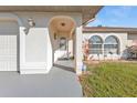 Inviting front entrance with decorative details, an ADT sign, and lush greenery at 25202 Chiclayo Ave, Punta Gorda, FL 33983