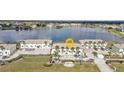 Aerial view of condos with lake view and parking lot at 26300 Rampart Blvd # 404, Punta Gorda, FL 33983