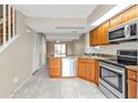 Open kitchen featuring stainless steel appliances and tile flooring at 26300 Rampart Blvd # 404, Punta Gorda, FL 33983