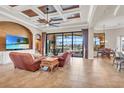 Spacious living room featuring coffered ceiling, tile flooring, and access to the outdoor patio at 3321 Tripoli Blvd, Punta Gorda, FL 33950