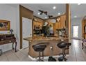 Eat-in kitchen featuring granite countertops, tile backsplash, stainless appliances, and seating at the breakfast bar at 4504 Vaquero St, North Port, FL 34286