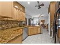 Inviting eat-in kitchen with granite countertops, tile backsplash, stainless appliances, and open to the living area at 4504 Vaquero St, North Port, FL 34286