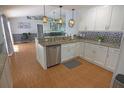 Bright kitchen featuring white cabinets, granite countertops, stainless steel appliances and decorative backsplash at 5131 Appomattox Dr, North Port, FL 34287
