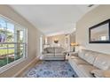 Inviting living room with tile flooring, large window, comfortable seating, and elegant accents at 1391 Abalom St, Punta Gorda, FL 33980