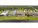 Aerial view of a home with a pool and backyard enclosed by black metal fencing at 158 Mariner Ln, Rotonda West, FL 33947