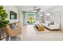 Bright living room with ceiling fan, sliding glass doors, and modern furnishings at 2138 Royal Tern Cir, Punta Gorda, FL 33983