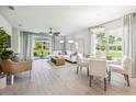 Bright living room with tile flooring, sliding glass doors, and modern furnishings at 2138 Royal Tern Cir, Punta Gorda, FL 33983