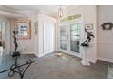 Elegant foyer featuring gray tile floors, an arched doorway, and decorative art pieces on display at 2479 Sonoma Dr W, Nokomis, FL 34275