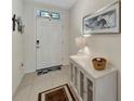 Welcoming entryway with tile flooring, elegant console table, and stylish decor at 3720 Pebble Ter, Punta Gorda, FL 33980