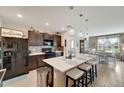 Spacious kitchen with quartz island, stainless steel appliances, and modern lighting at 3720 Pebble Ter, Punta Gorda, FL 33980