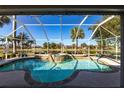 Relaxing screened-in pool with in-ground spa and lovely waterfront views at 483 Corrientes Cir, Punta Gorda, FL 33983