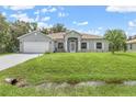 Well-maintained single Gathering home with two-car garage, manicured lawn, and excellent curb appeal at 5366 Dunsmuir Rd, North Port, FL 34288