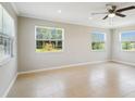 Bright living room with tile floors, a ceiling fan, and large windows offering ample natural light at 556 Lowell Nw Ave, Port Charlotte, FL 33952