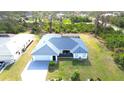 Charming single-story home featuring a well-manicured lawn, mature landscaping and attached two car garage at 6170 David Blvd, Port Charlotte, FL 33981