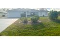 Charming single-story home featuring a well-manicured lawn and mature landscaping at 6170 David Blvd, Port Charlotte, FL 33981