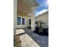 Inviting entryway featuring a paved walkway, double doors, and fresh landscaping at 6372 Grove Blvd, Punta Gorda, FL 33982