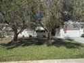 Charming single-story home featuring a well-manicured lawn, crisp white paint, and an American flag at 710 Aqui Esta Dr, Punta Gorda, FL 33950