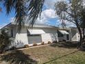Charming single-story home featuring a well-manicured lawn and crisp white paint at 710 Aqui Esta Dr, Punta Gorda, FL 33950