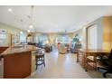 Spacious living area flows seamlessly from the kitchen, featuring bright, natural light and tile flooring throughout at 7346 Talon Bay Dr, North Port, FL 34287