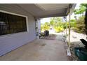 View of the back porch with palm tree decorations and an air conditioning unit at 21422 Mallory Ave, Port Charlotte, FL 33952